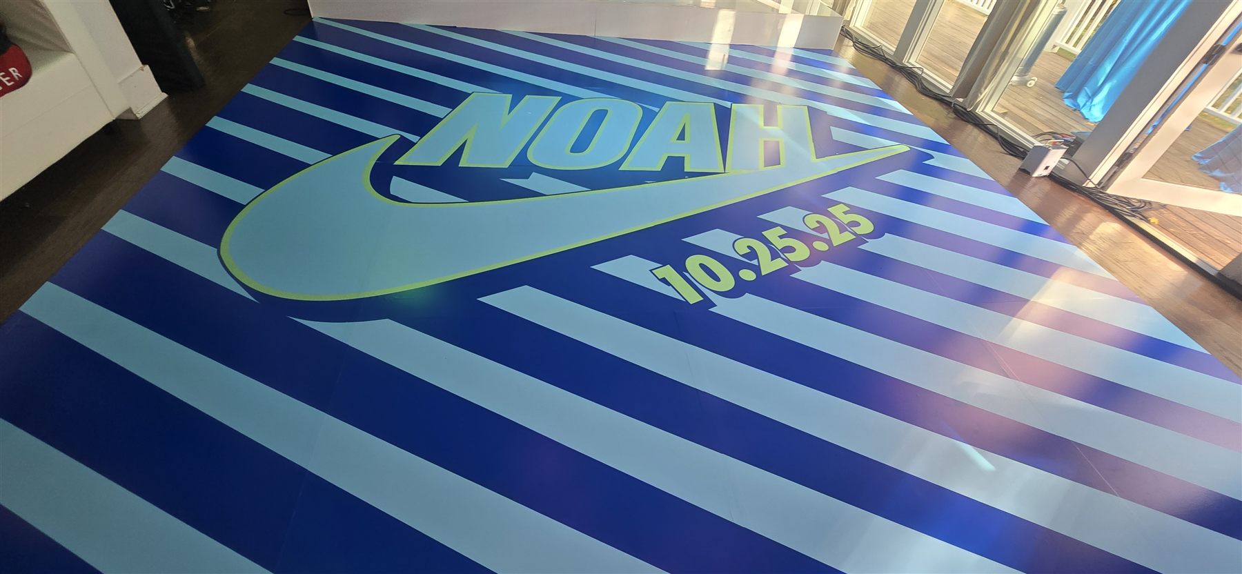 Custom-printed striped logo dance floor by Adicora